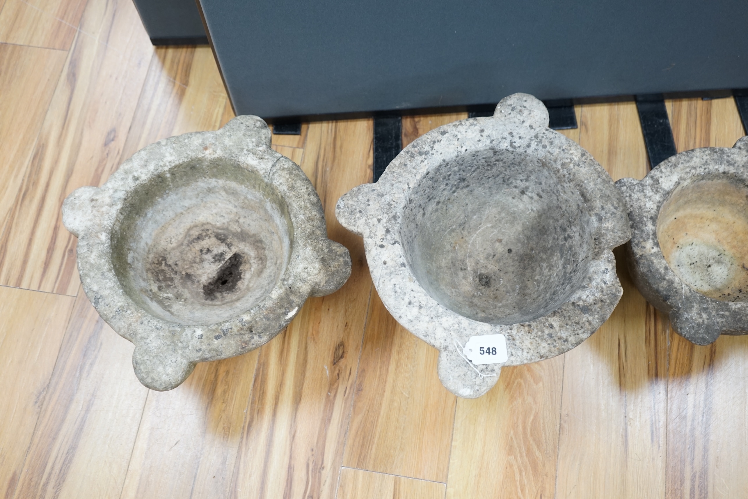 Four graduated marble mortars, largest 46.5cm wide across top rim. Condition - largest mortar has a handle missing, all have been stored outside and are marked